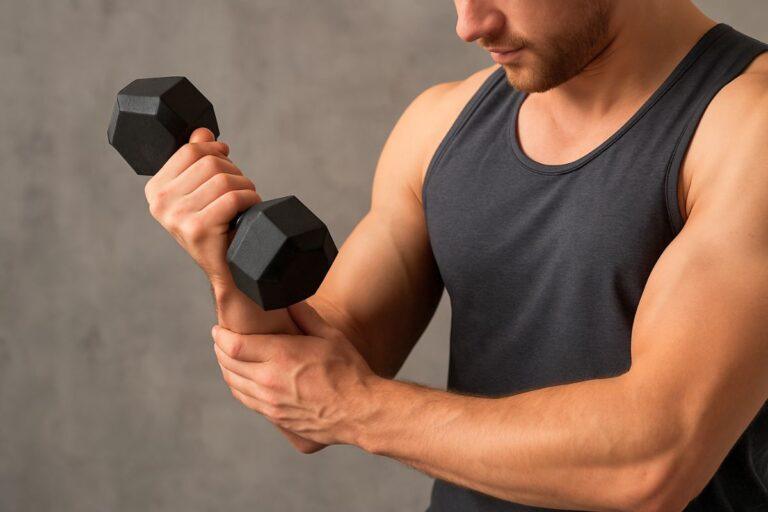 a man doing forearm exercises with dumbbell