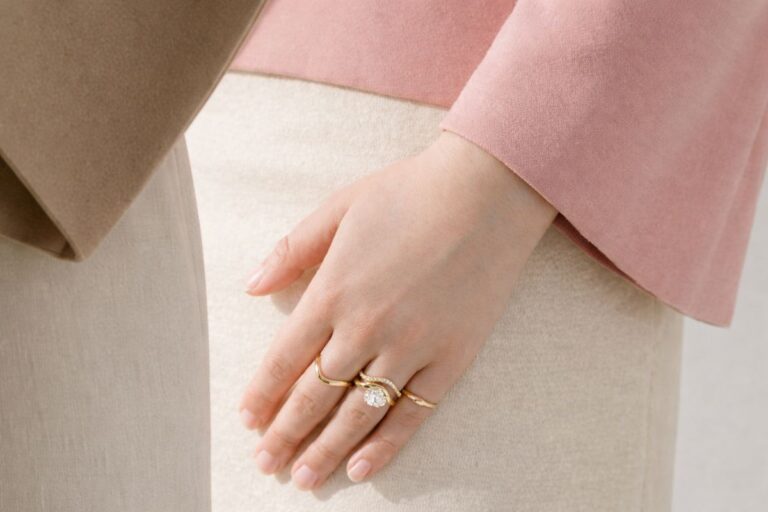 a girl wearing a cushion cut engagement ring in her left hand's finger