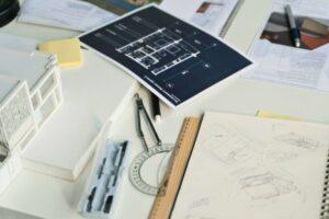 construction consultants project work documents and tools placed on a table together