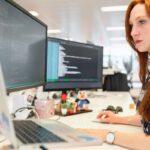 a girl is working one computers for web development services